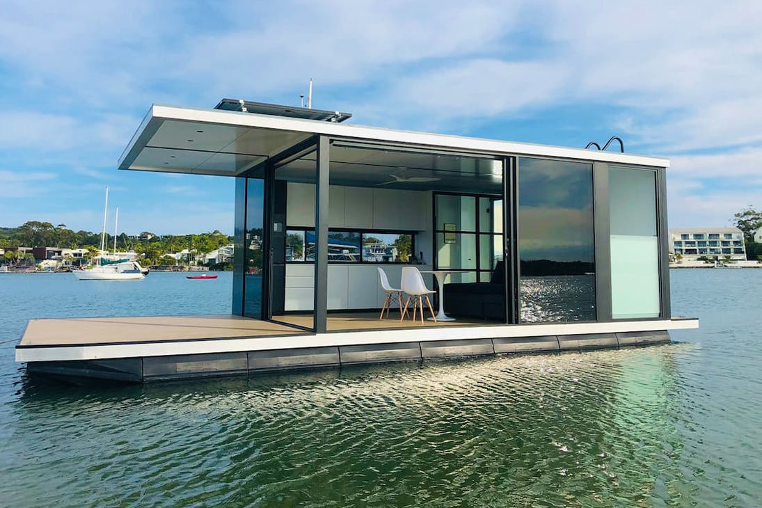 a small houseboat on calm water
